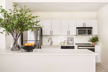 A kitchen with white cabinets and a white countertop. at Southpark Commons Apartment Homes, Charlotte